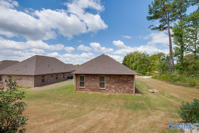 rear view of house featuring a yard