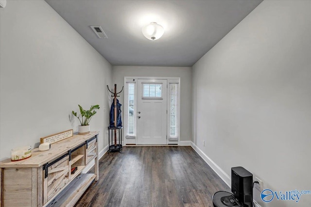 entryway featuring visible vents, baseboards, and dark wood-style flooring