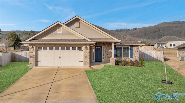 view of front of house with a front lawn, fence, a garage, and driveway