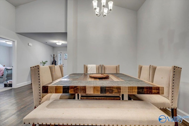 dining area featuring wood finished floors, baseboards, and a chandelier