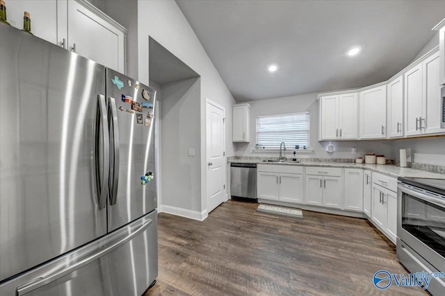 kitchen with a sink, appliances with stainless steel finishes, dark wood-style flooring, and white cabinetry