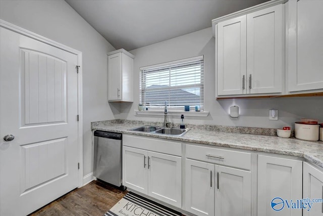 kitchen with dark wood finished floors, dishwasher, white cabinetry, and a sink