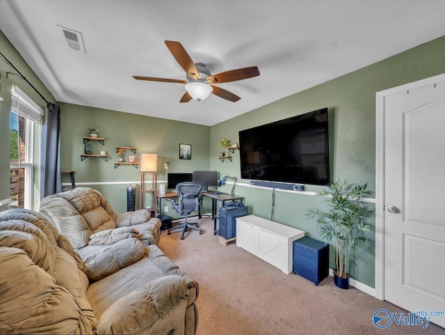 living room with visible vents, ceiling fan, baseboards, and carpet floors