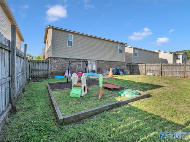 view of jungle gym featuring a fenced backyard and a lawn