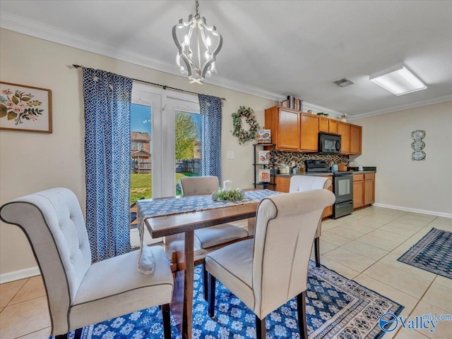 dining area with light tile patterned floors, visible vents, an inviting chandelier, and crown molding