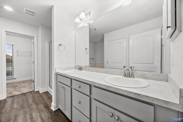 full bath with visible vents, a sink, and a stall shower