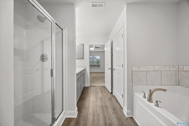 full bath featuring a stall shower, visible vents, a bath, and vanity