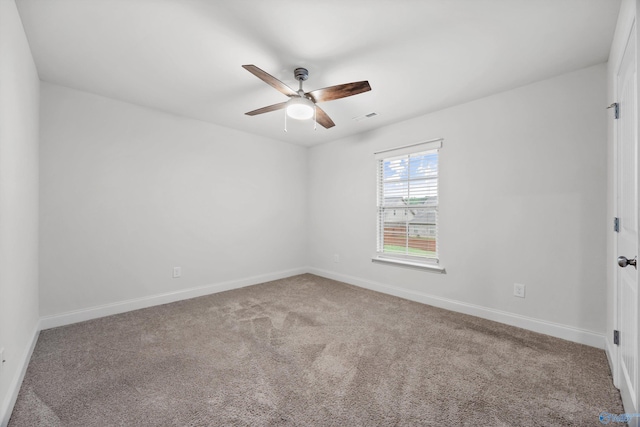 carpeted empty room with a ceiling fan, baseboards, and visible vents