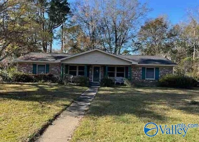 single story home with a porch and a front lawn