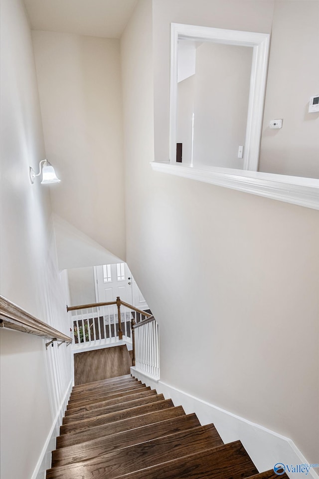 stairs featuring wood-type flooring