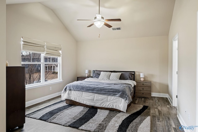 bedroom with ceiling fan, vaulted ceiling, and hardwood / wood-style floors