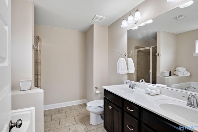 bathroom featuring vanity, toilet, an enclosed shower, and tile patterned flooring