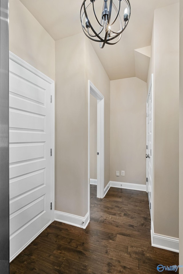 foyer with lofted ceiling, a chandelier, and dark hardwood / wood-style flooring