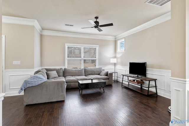 living room featuring crown molding, dark hardwood / wood-style floors, ceiling fan, and ornate columns