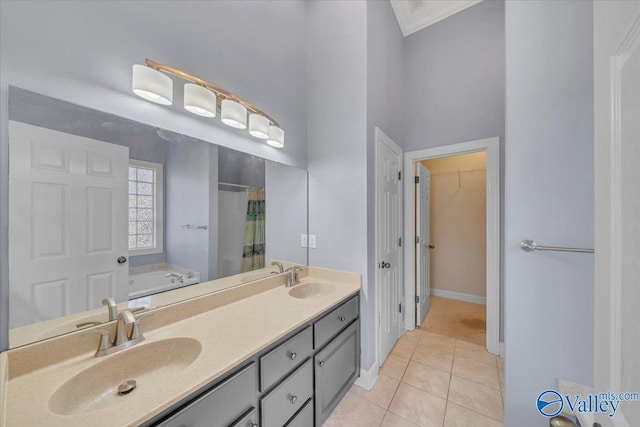 bathroom with tile patterned flooring, a sink, and a bath