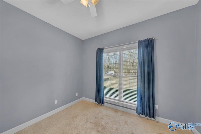 empty room with baseboards, ceiling fan, and carpet floors