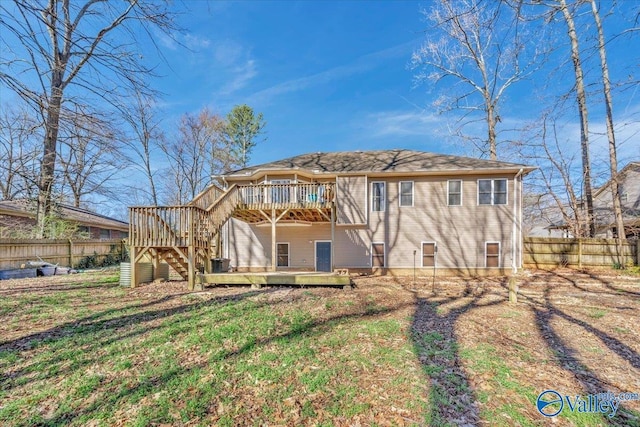 rear view of property featuring a deck, stairway, and fence