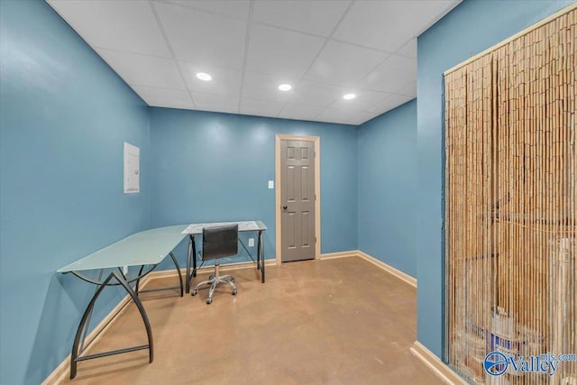 office featuring finished concrete flooring, baseboards, recessed lighting, and a paneled ceiling