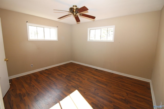 unfurnished room with ceiling fan and dark hardwood / wood-style flooring