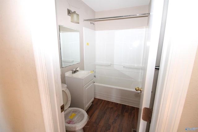 full bathroom featuring wood-type flooring, tub / shower combination, vanity, and toilet