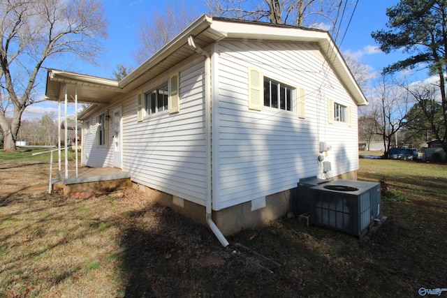 view of home's exterior with a yard and central AC unit