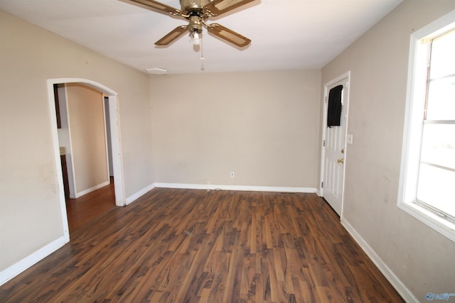 empty room featuring ceiling fan and dark hardwood / wood-style flooring