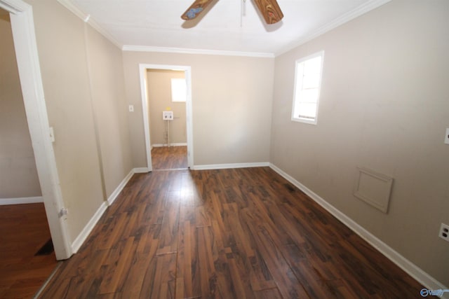 empty room with crown molding, dark wood-type flooring, and ceiling fan