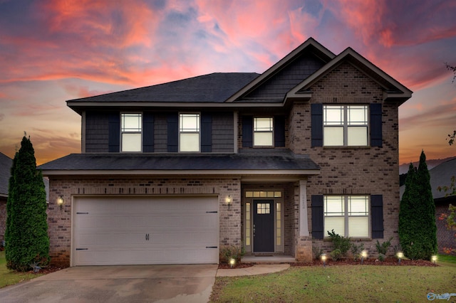 view of front of home with a lawn and a garage