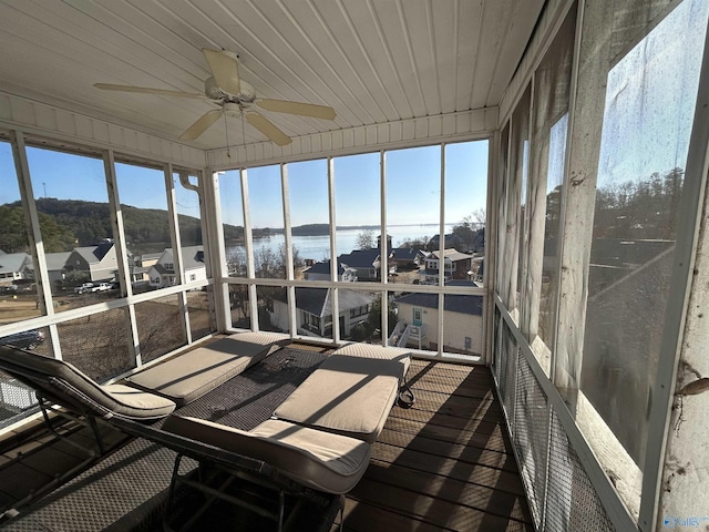 unfurnished sunroom with wooden ceiling and ceiling fan