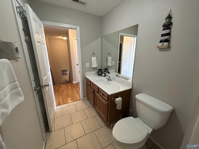 bathroom with vanity, tile patterned floors, and toilet