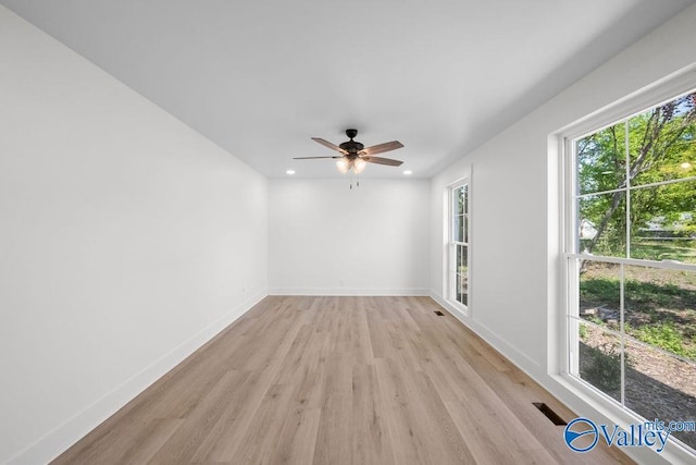 empty room featuring recessed lighting, ceiling fan, baseboards, and light wood-type flooring