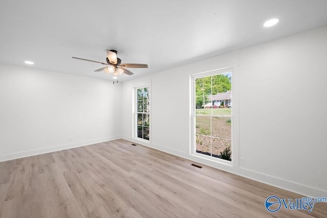 unfurnished room with light wood finished floors, a ceiling fan, baseboards, and recessed lighting