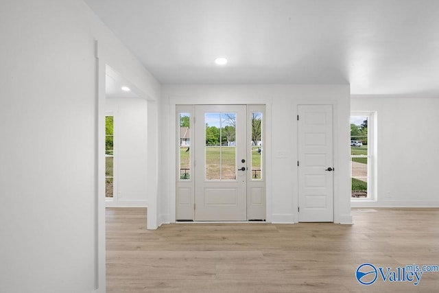 entrance foyer with baseboards, wood finished floors, and recessed lighting