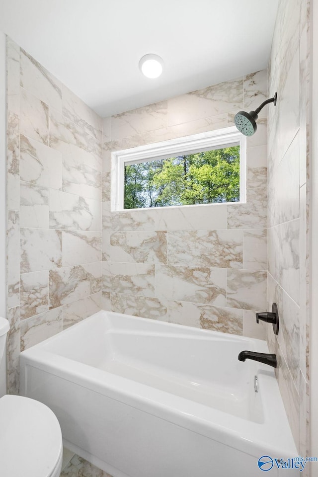 bathroom with toilet and shower / tub combination