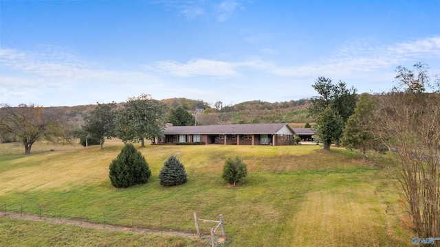 view of front facade with a rural view and a front yard