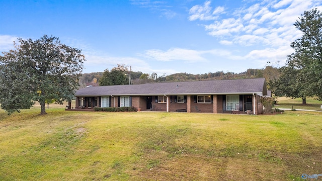 ranch-style home featuring a front yard