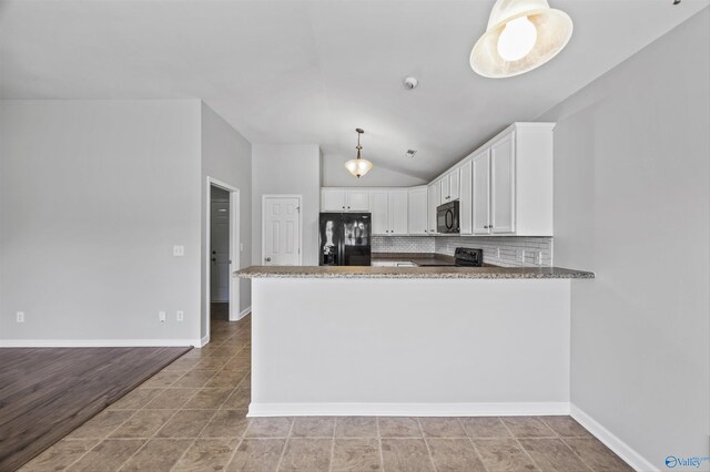 377 Robinson Rd, Huntsville, AL 35811 - kitchen featuring black appliances, light stone counters, white cabinets, lofted ceiling, and tasteful backsplash