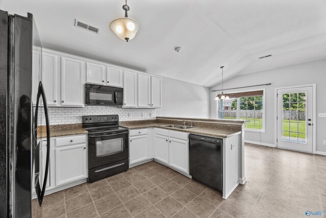 377 Robinson Rd, Huntsville, AL 35811 - kitchen with black appliances, dark countertops, lofted ceiling, white cabinets, and pendant lighting