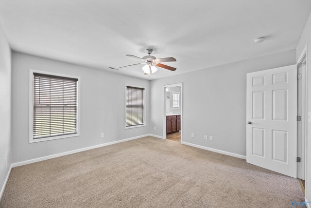 377 Robinson Rd, Huntsville, AL 35811 - unfurnished bedroom with light carpet, ensuite bathroom, and ceiling fan