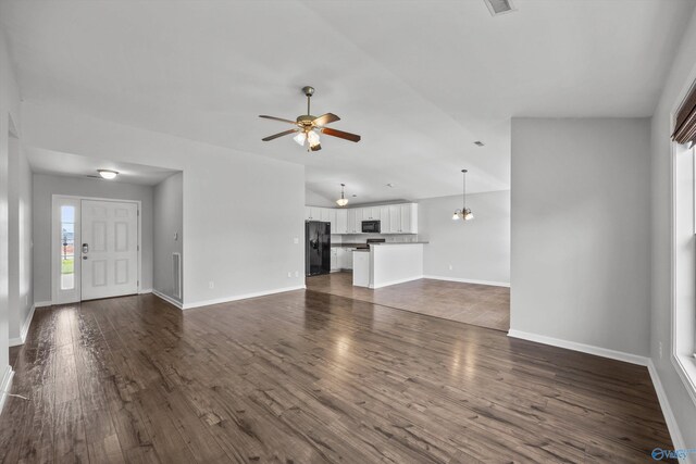 377 Robinson Rd, Huntsville, AL 35811 - unfurnished living room featuring a ceiling fan, dark wood-style flooring, lofted ceiling, and a chandelier