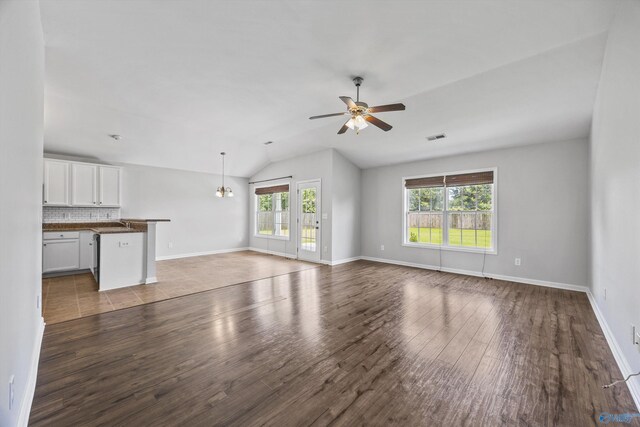 377 Robinson Rd, Huntsville, AL 35811 - unfurnished living room featuring plenty of natural light, ceiling fan, vaulted ceiling, and wood finished floors