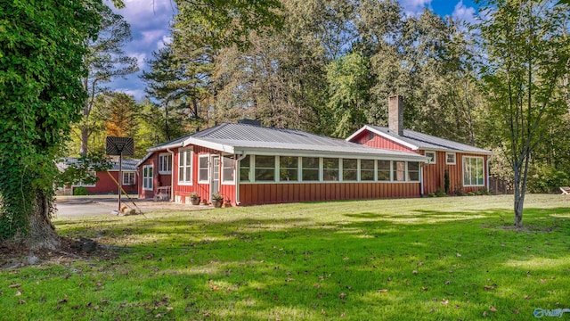 view of front of house featuring a front lawn and a sunroom