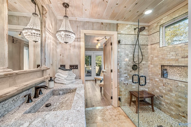 bathroom with a shower with door, wooden walls, wood-type flooring, and wooden ceiling