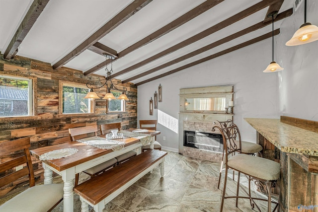 dining area with vaulted ceiling with beams