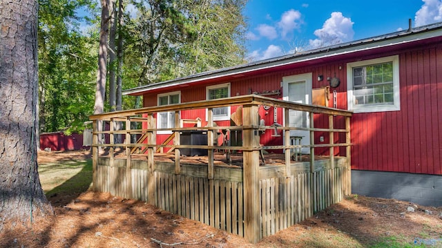 rear view of property with a wooden deck