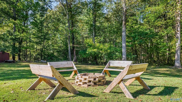 exterior space featuring a lawn and a fire pit