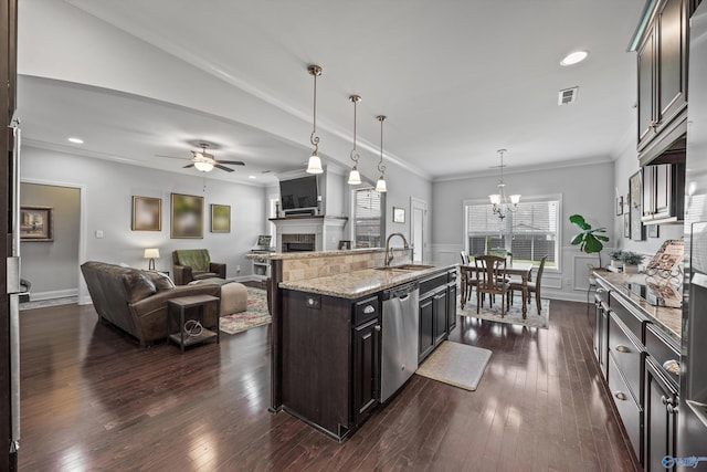 kitchen with a sink, a fireplace, dishwasher, open floor plan, and visible vents
