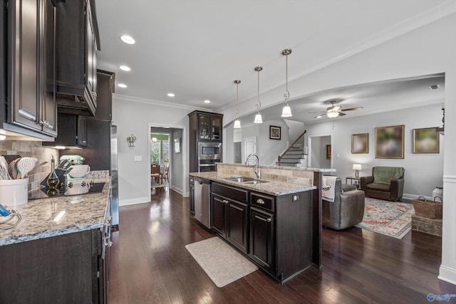 kitchen with open floor plan, an island with sink, black electric cooktop, tasteful backsplash, and a sink