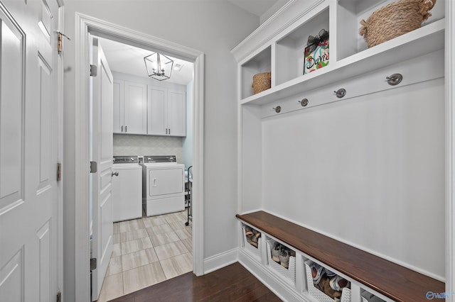 mudroom with baseboards, washing machine and dryer, and a notable chandelier