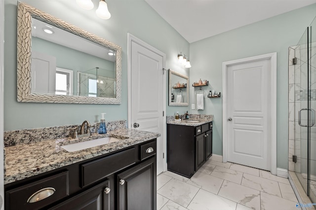 bathroom with two vanities, a sink, marble finish floor, and a stall shower